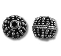 Two ornate round metal spacer beads