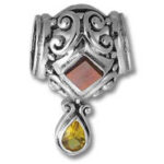 Silver filigree charm with red and yellow gems
