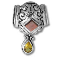 Silver filigree charm with red and yellow gems