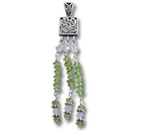 Silver filigree pendant with green bead tassels