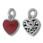 Two heart-shaped silver and red charms