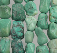 Green turquoise tumbled stones arranged in rows