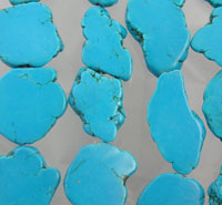 Turquoise stone slices on gray background