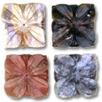 Four carved square floral stone beads