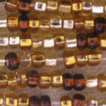 Close-up of gold and amber seed beads