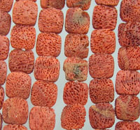 Rows of red-orange porous square beads