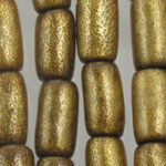 Close-up of gold textured cylindrical beads
