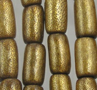 Close-up of gold textured cylindrical beads