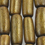 Textured gold-toned cylindrical beads close-up
