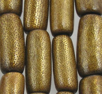 Textured gold-toned cylindrical beads close-up