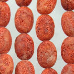 Close-up of red porous bead strands
