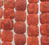 Rows of red porous cube beads