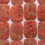 Red textured rectangular beads in grid