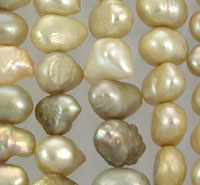 Strands of irregular golden baroque pearls