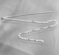 Silver chain threader earring on gray fabric