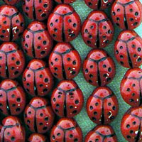 Patterned red ladybugs on green background