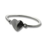Silver ring with heart-shaped charm