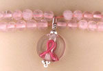 Pink beaded bracelet with breast cancer ribbon charm