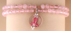 Pink beaded bracelet with breast cancer ribbon charm
