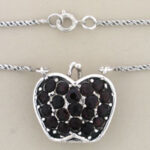 Silver heart pendant with black gemstones on chain