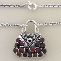 Silver handbag pendant necklace with red gemstones