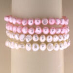 Stacked pink and white freshwater pearl bracelets