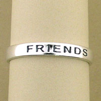 Silver band engraved with "FRIENDS