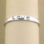 Silver bangle engraved with Love