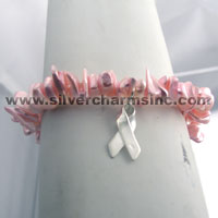 Pink beaded bracelet with silver ribbon charm
