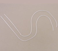 Two white cords curved on beige background