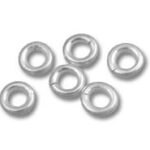 Small silver metal washers on white background