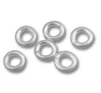 Small silver metal washers on white background