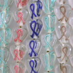 Rows of colorful awareness ribbon glass charms