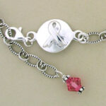 Silver awareness ribbon charm bracelet with pink bead