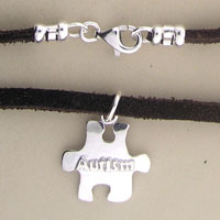 Silver puzzle piece pendant on black cord