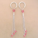 Silver hoop earrings with pink bead tassels