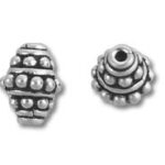 Two ornate silver spacer beads