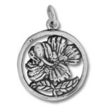 Round silver pendant featuring floral relief
