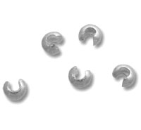 Silver crimp bead covers on white background