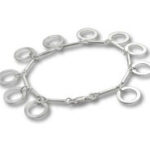 Silver bracelet with dangling circular hoop charms