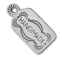 Silver stamped metal tag reading "HANDMADE
