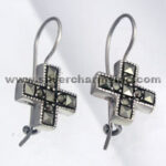 Silver cross dangle earrings with black stones