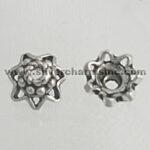 Two silver star-shaped bead caps
