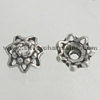 Two silver star-shaped bead caps