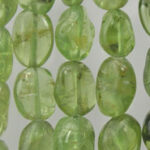 Close-up of translucent green oval beads