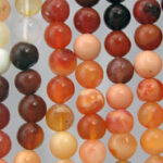 strands of round orange, brown gemstone beads
