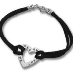 Black cord bracelet with silver heart charm