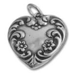 Ornate silver heart locket pendant with floral design