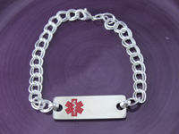 Silver medical ID bracelet with red emblem