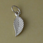 Silver leaf pendant on olive green background